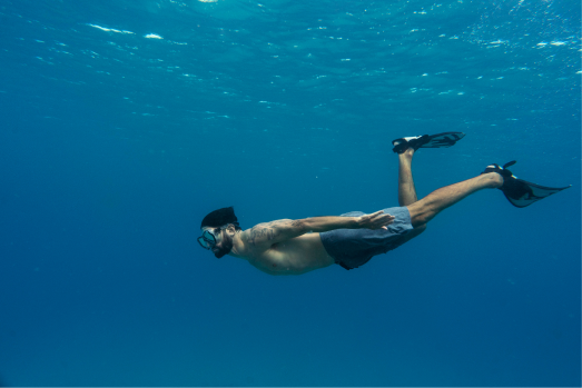 A man submerge underwater on the blue ocean